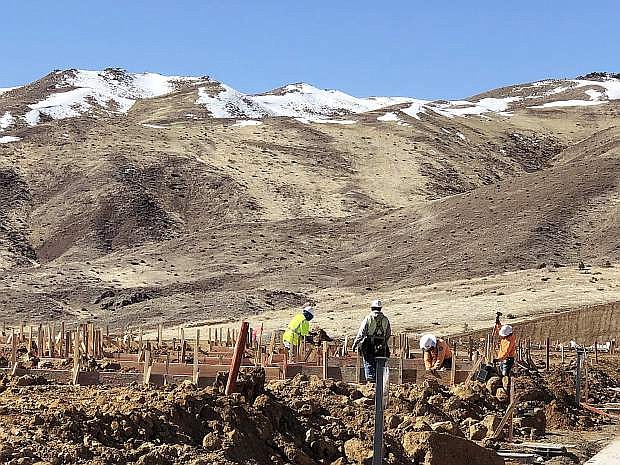Crews work March 15 on building homes at The Cliffs at Somersett, a planned luxury home community being developed by Toll Brothers on the south of flank of Peavine Peak in Northwest Reno.