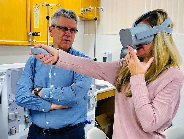 XR Libraries director John McLeod talks with Kristi Kilcko, of the Medical Education Institute, about the role of virtual reality equipment in matching workers with careers. Photo courtesy of Tammy Westergard/Nevada State Library, Archives and Public Records