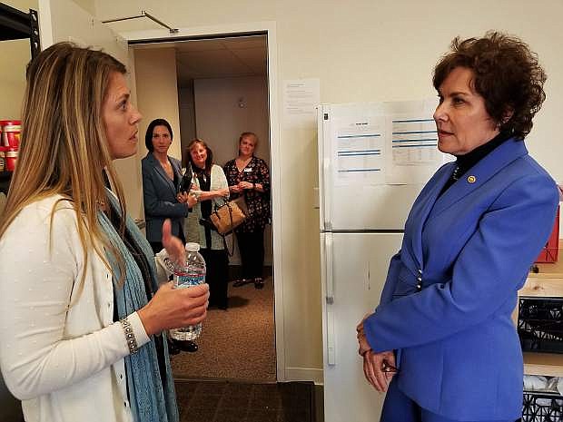 Sen. Jacky Rosen, right, speaks with Heather Simola, Nevada Rural Housing Authority, in the food pantry at Richards Crossing.