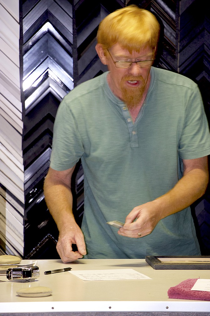 Dan Larson works inside his business, The Frame Shop at Lakeside, on Lakeside Drive in Reno.