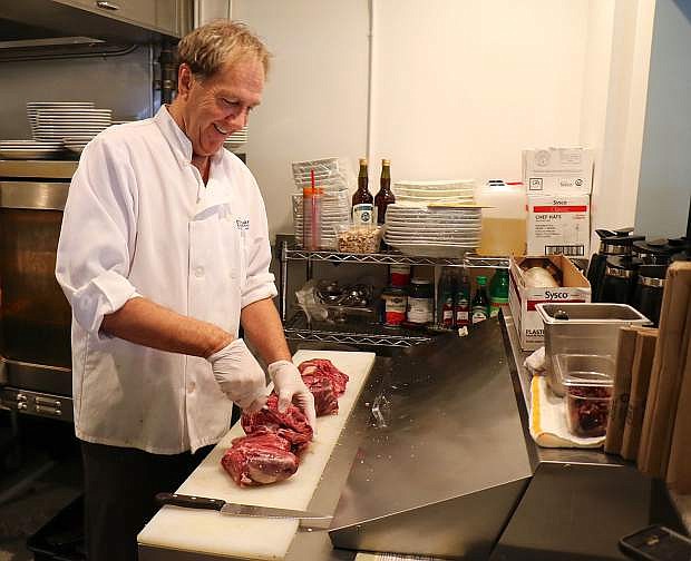 Gather Chef Howard Jachens breaks down a hunk of lamb meat as he preps for the dinner rush.