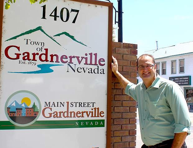 Matt Brubeck poses with the new Gardnerville and Main Street Gardnerville sign on Monday in downtown Gardnerville.