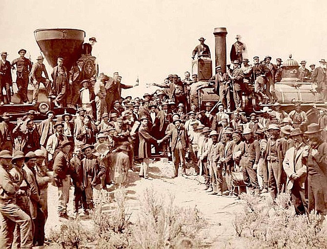 The ceremony for the driving of the golden spike at Promontory Summit, Utah on May 10, 1869. marked completion of the First Transcontinental Railroad. At center left, Samuel S. Montague, Central Pacific Railroad, shakes hands with Grenville M. Dodge, Union Pacific Railroad (center right).