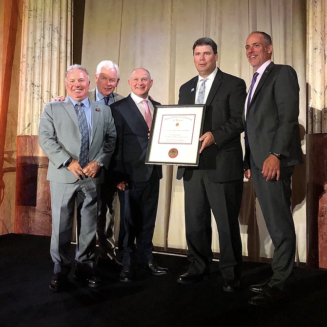 The Nevada AGC received a national award from the AGC of America for its 80th anniversary project, the rebuilding of the entrance gate at the Grand Army of the Republic Cemetery. Pictured, left to right, are AGC officers Bob Gardner, first V.P. (Gardner Engineering, Inc.); Nathan Roach, president (Gradex Construction Co.); Marc Markwell, second V.P. (Sierra Nevada Construction, Inc.); National Director, Justin Ivory (A-1 Steel, Inc.); and Dirk Elsperman, president, AGC of America.
