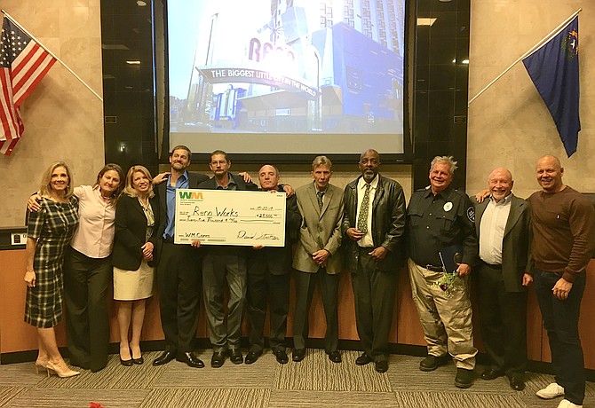 The nine newest graduates of the Reno Works program were honored Oct. 22 at City Hall; here, they&#039;re pictured with the Waste Management check, along with Councilmember Neoma Jardon (far left) and Volunteers of America Regional Director Pat Cashell (far right).