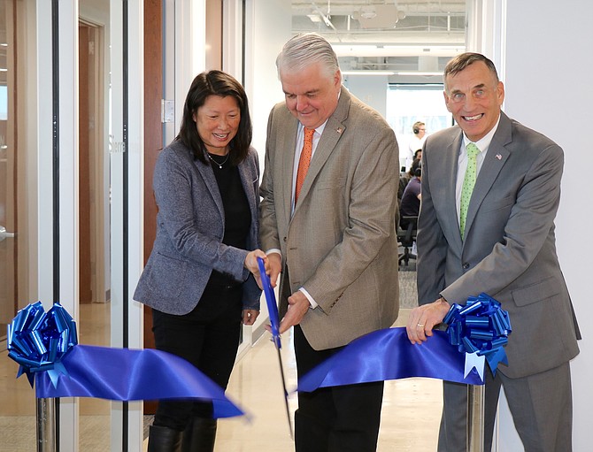 Figure COO June Ou, left, Gov. Steve Sisolak and EDAWN CEO Mike Kazmierski cut the ribbon at Figure&#039;s new 12,500-square-foot office in downtown Reno on Tuesday, Feb. 18. 