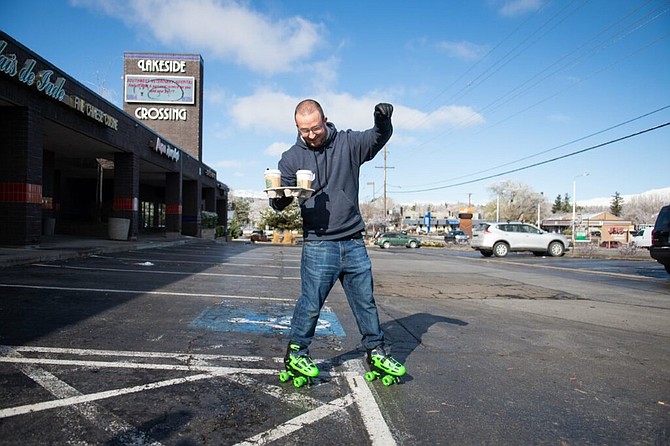 Coffee N&#039; Comics owner, Alex Farside carries and order out to an Uber Eats driver on Thursday, March 19, 2020 in Reno, Nev. (David Calvert/The Nevada Independent)