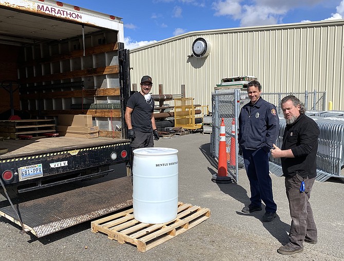 Jim Pisciotti, Bently Heritage&#039;s Production Process Specialist, meets with members of Carson Health and Human Services in late March to deliver a 550-gallon drum of hand sanitizer. 