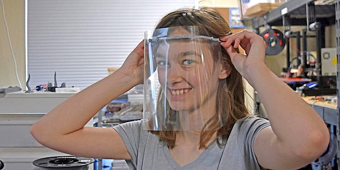 Hailey Muth, daughter of Katie and Andy, models a visor and shield the company is producing amid the COVID-19 pandemic.