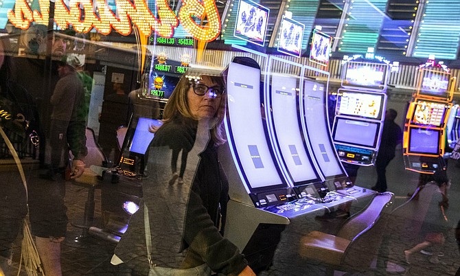 A woman walks past shutdown gaming machine at Golden Nugget on Tuesday, March 17, 2020.