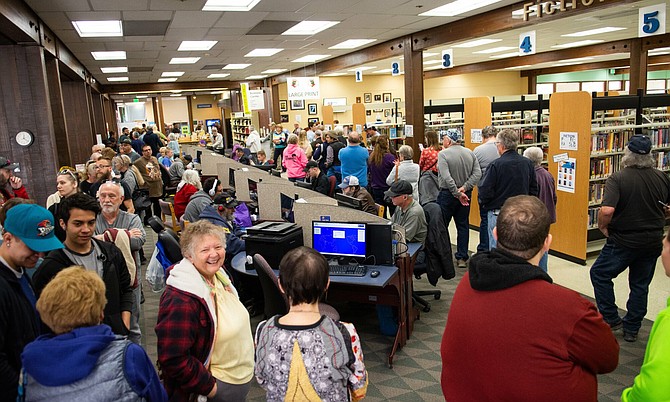 More than 300 Democratic voters wait in line inside Sparks branch of the Washoe County Library in Sparks, Nev. on Saturday, Feb. 15, 2020, the first day of early voting.