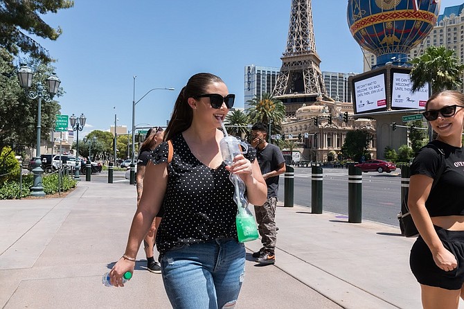 A few friends walk down the Las Vegas Strip with yard long drinks while various properties reopen to the public after a temporary shutdown caused by the COVID-19 health pandemic on Thursday, June 4, 2020.