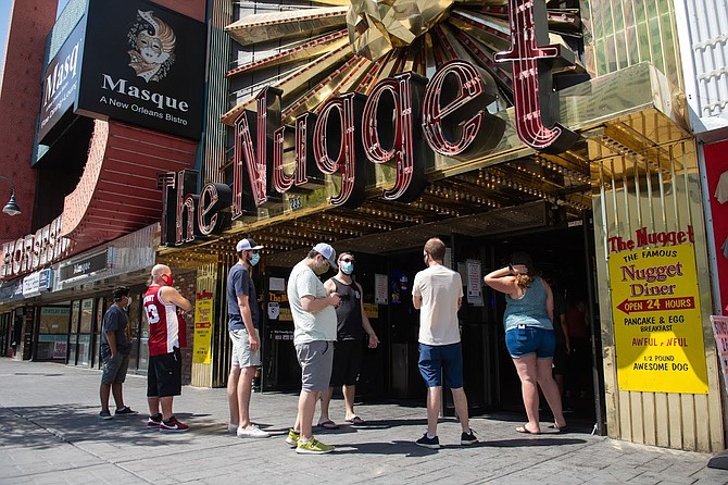 People wait in line to order an Awful Awful burger from the Little Nugget in Downtown Reno on Friday, July 24, 2020. The longtime downtown business will close for good July 31.