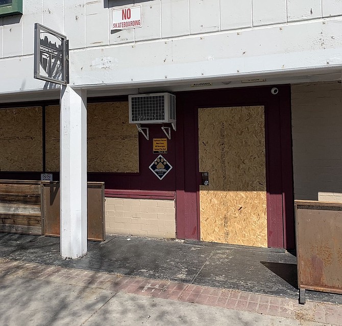 Sierra Tap House in downtown Reno is seen March 21, boarded up and closed during the first round of mandatory closures this spring. After reopening in June, the bar is among hundreds in the state that re-closed July 10 due to state orders.