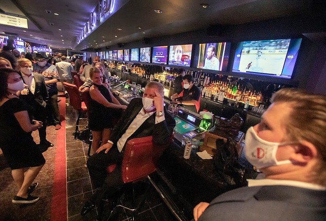 Derek Stevens, center, owner of The D, sits at the Long Bar on Thursday, June 4, 2020. Nevada casinos have been shut down for nearly three month because of COVID-19. 