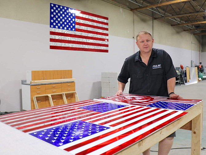 Scott Stites, owner of Sparks Metalcrafters, stands inside his shop in Sparks, where he makes patriotic and veteran-themed metal art. Stites, a U.S. Marine Corps veteran, says his company has seen 25-30% growth year-over-year since launching in 2015. 