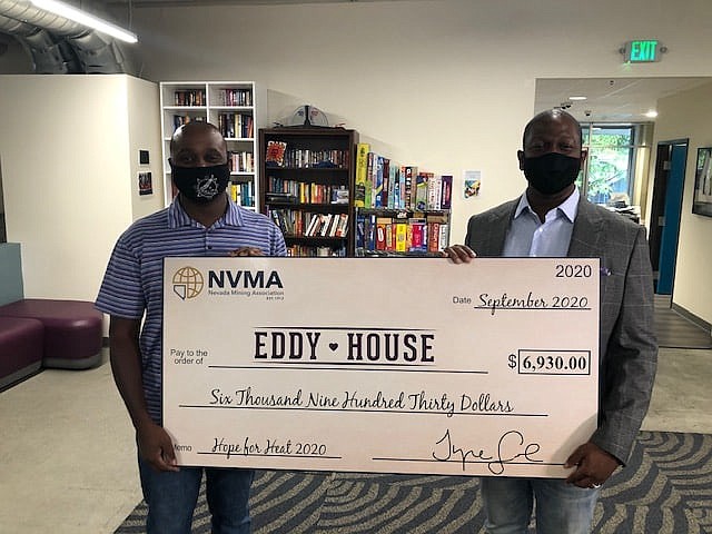 Nevada Mining Association President Trye Gray, right, presents the donation check on Oct 1 to Diaz Dixon, CEO of the nonprofit Eddy House in Reno.