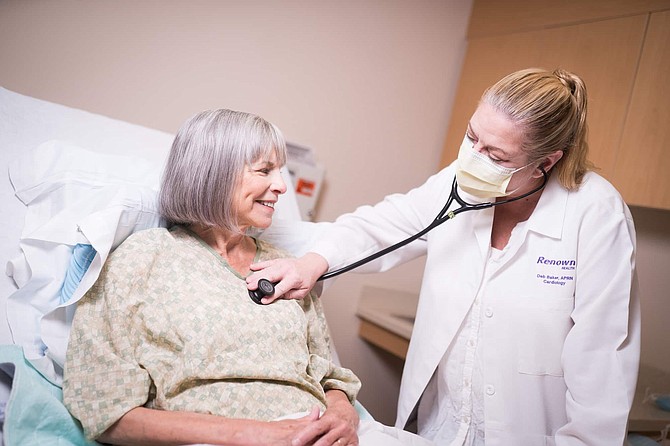 Deb Baker, an APRN with Renown Health, checks the vitals of a patient at Renown Regional Medical Center in July. In the COVID era, these types of in-person visits may not be as frequent, especially for those living in rural Nevada.