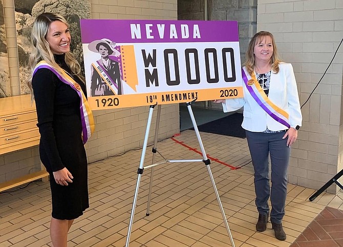 In this September photo, WNC student Maxine Thew, left, and Molly Walt of the Nevada Commission for Women pose with the specialty license plate they collaborated to create to commemorate the 100th anniversary of women being able to vote.